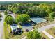 Aerial view of a community pool and two tennis courts in a neighborhood setting, with surrounding green space at 2181 Poplar Grove Ct, Snellville, GA 30078