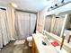 Bathroom featuring neutral colors, a bathtub shower with a shower curtain, and a single sink vanity with a stone countertop at 635 Sw Queen Sw St, Atlanta, GA 30310