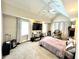 Bedroom with light gray carpet, ceiling fan, large TV on a wooden shelf, and many boxes and luggage at 635 Sw Queen Sw St, Atlanta, GA 30310