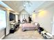 Bedroom with light gray carpet, ceiling fan, large TV on a wooden shelf, and many boxes and luggage at 635 Sw Queen Sw St, Atlanta, GA 30310