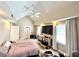 Bedroom with light gray carpet, ceiling fan, large TV on a wooden shelf, and many boxes and luggage at 635 Sw Queen Sw St, Atlanta, GA 30310