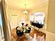 Dining room with hardwood floors, glass table, velvet chairs, a chandelier, and wainscoting at 635 Sw Queen Sw St, Atlanta, GA 30310