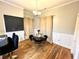 Formal dining room with hardwood floors, wainscoting, a chandelier, and a glass table with velvet chairs at 635 Sw Queen Sw St, Atlanta, GA 30310