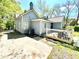 Exterior view of a light grey home with an outdoor patio and driveway at 635 Sw Queen Sw St, Atlanta, GA 30310