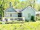 Charming home with front porch, light grey siding, and black trim at 635 Sw Queen Sw St, Atlanta, GA 30310