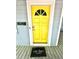 Bright yellow front door with decorative window, paired with 'cute shoes' doormat at 635 Sw Queen Sw St, Atlanta, GA 30310