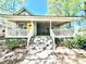 Inviting home with a spacious front porch, featuring seating area, perfect for relaxing at 635 Sw Queen Sw St, Atlanta, GA 30310