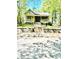 Charming home featuring a welcoming front porch, complemented by verdant landscaping and stone steps at 635 Sw Queen Sw St, Atlanta, GA 30310