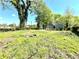 Well-maintained home featuring a covered porch and a spacious front yard surrounded by trees at 635 Sw Queen Sw St, Atlanta, GA 30310