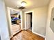 Bright hallway with hardwood floors and a view into the kitchen with stainless steel appliances at 635 Sw Queen Sw St, Atlanta, GA 30310