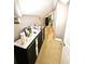 Hallway featuring storage, grey paint and tan flooring at 635 Sw Queen Sw St, Atlanta, GA 30310