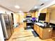 Kitchen featuring wood cabinets, stainless steel appliances, an island, and hardwood flooring at 635 Sw Queen Sw St, Atlanta, GA 30310