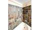 Shower with multicolored square tile surround and a chrome shower head and faucet at 635 Sw Queen Sw St, Atlanta, GA 30310