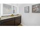 Bathroom with dual sinks, granite counters, modern lighting, and framed botanical art at 734 Great Oak Pl, Villa Rica, GA 30180