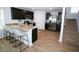 Modern kitchen with dark cabinets, granite countertops, stainless steel appliances, and a breakfast bar at 734 Great Oak Pl, Villa Rica, GA 30180