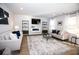 Bright living room is spacious with modern decor, large windows, and stylish furniture at 734 Great Oak Pl, Villa Rica, GA 30180