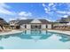 Community pool with lounge seating, tables, and umbrellas with the clubhouse in the background at 1030 Sutherland Lane (Lot 46), Lawrenceville, GA 30043