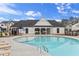 Low-angle view of the neighborhood pool and clubhouse with a nice view of lounge seating and tables at 1030 Sutherland Lane (Lot 46), Lawrenceville, GA 30043