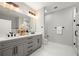 Bright bathroom boasts double sinks, quartz counters, matte black hardware, and walk-in shower at 106 Hogue St, Atlanta, GA 30312