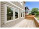 Spacious wood deck, tan siding, trimmed windows, and exterior view of neighboring property at 106 Hogue St, Atlanta, GA 30312