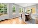 Bright dining area with hardwood floors, large windows, and a door leading to an outdoor deck at 106 Hogue St, Atlanta, GA 30312