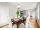 Elegant dining room featuring hardwood floors, modern lighting, and views into the adjoining kitchen at 106 Hogue St, Atlanta, GA 30312