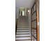 Sunlit staircase with neutral walls, hardwood treads, and a craftsman style door at 106 Hogue St, Atlanta, GA 30312