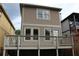 The tan-colored home features a deck with white railings and tan siding and white trim at 106 Hogue St, Atlanta, GA 30312