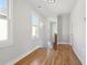 Hallway with wooden floors, natural light, and staircase with wooden banister at 106 Hogue St, Atlanta, GA 30312