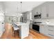 Contemporary kitchen with stainless steel appliances, gray cabinets, and an island with bar stools at 106 Hogue St, Atlanta, GA 30312