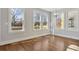 Sun-filled living space showcasing hardwood floors, multiple large windows, and recessed lighting at 106 Hogue St, Atlanta, GA 30312