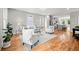 Open-concept living room with hardwood floors flowing into a kitchen, furnished with modern sofas and chairs at 106 Hogue St, Atlanta, GA 30312