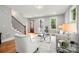 Bright living room with hardwood floors, modern furniture, and a staircase with dark metal spindles at 106 Hogue St, Atlanta, GA 30312