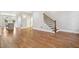 Hardwood floors connecting the living room to the kitchen, plus a staircase with wooden steps and metal railings at 106 Hogue St, Atlanta, GA 30312