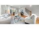 Spacious living room with hardwood floors, open to the kitchen, and featuring a staircase with wood accents at 106 Hogue St, Atlanta, GA 30312