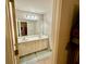 Bathroom featuring double sinks, vanity with storage, and tile floor at 3240 Letha Woods Sw Dr, Conyers, GA 30094