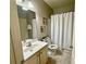 Neutral bathroom features a shower with white curtain, toilet, and vanity with sink at 3240 Letha Woods Sw Dr, Conyers, GA 30094