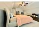 Bedroom features plush carpet, neutral walls, ceiling fan, bed with tan headboard and peach bedding at 3240 Letha Woods Sw Dr, Conyers, GA 30094