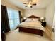 Comfortable bedroom with neutral carpet, a ceiling fan, a large window, and a king-size bed at 3240 Letha Woods Sw Dr, Conyers, GA 30094