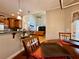 Open-concept dining area showcasing hardwood floors, modern lighting, and seamless flow to the living room at 3240 Letha Woods Sw Dr, Conyers, GA 30094