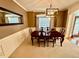 Formal dining room with large dining table and chairs set beneath a contemporary chandelier light fixture at 3240 Letha Woods Sw Dr, Conyers, GA 30094