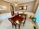 Formal dining room featuring a long dining table set for six, crown molding and large mirror at 3240 Letha Woods Sw Dr, Conyers, GA 30094