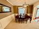 Formal dining room featuring a large table, elegant lighting, and neutral decor at 3240 Letha Woods Sw Dr, Conyers, GA 30094