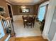Dining room boasts carpeted floors, brown walls, white molding, hanging light, window, and dining table with six chairs at 3240 Letha Woods Sw Dr, Conyers, GA 30094