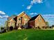 Beautiful two-story brick home featuring a manicured lawn and landscaping with colorful bushes at 3240 Letha Woods Sw Dr, Conyers, GA 30094