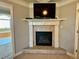 Living room fireplace, topped with a TV, features an entrance to the primary bath at 3240 Letha Woods Sw Dr, Conyers, GA 30094