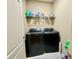 Convenient laundry room with modern washer and dryer, plus storage space at 3240 Letha Woods Sw Dr, Conyers, GA 30094