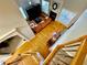 Aerial view of a living room features hardwood floors, fireplace, mantel, television, staircase, and orange couch at 3240 Letha Woods Sw Dr, Conyers, GA 30094