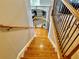 Staircase features hardwood steps, wrought iron spindles, and leads to a room with hardwood floors at 3240 Letha Woods Sw Dr, Conyers, GA 30094