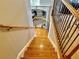 Wooden staircase featuring wood railing with metal spindles and carpet on the lower level landing at 3240 Letha Woods Sw Dr, Conyers, GA 30094